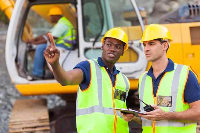 Construction managers reviewing work on site