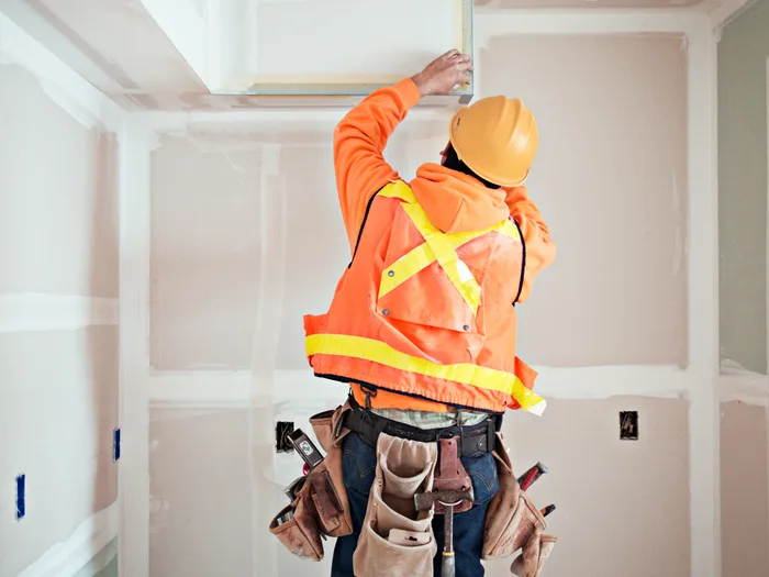 Construction worker wearing a hard hat and high-visibility vest
